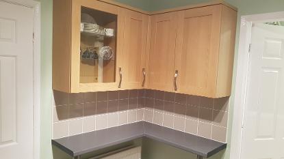 Fitting of units and breakfast bar and tiling