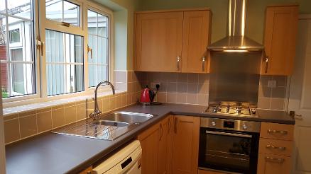 Kitting of worktops, units,sink,oven,hob and extractor. Tiling.